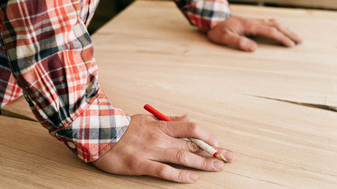 A person with their hand on the table