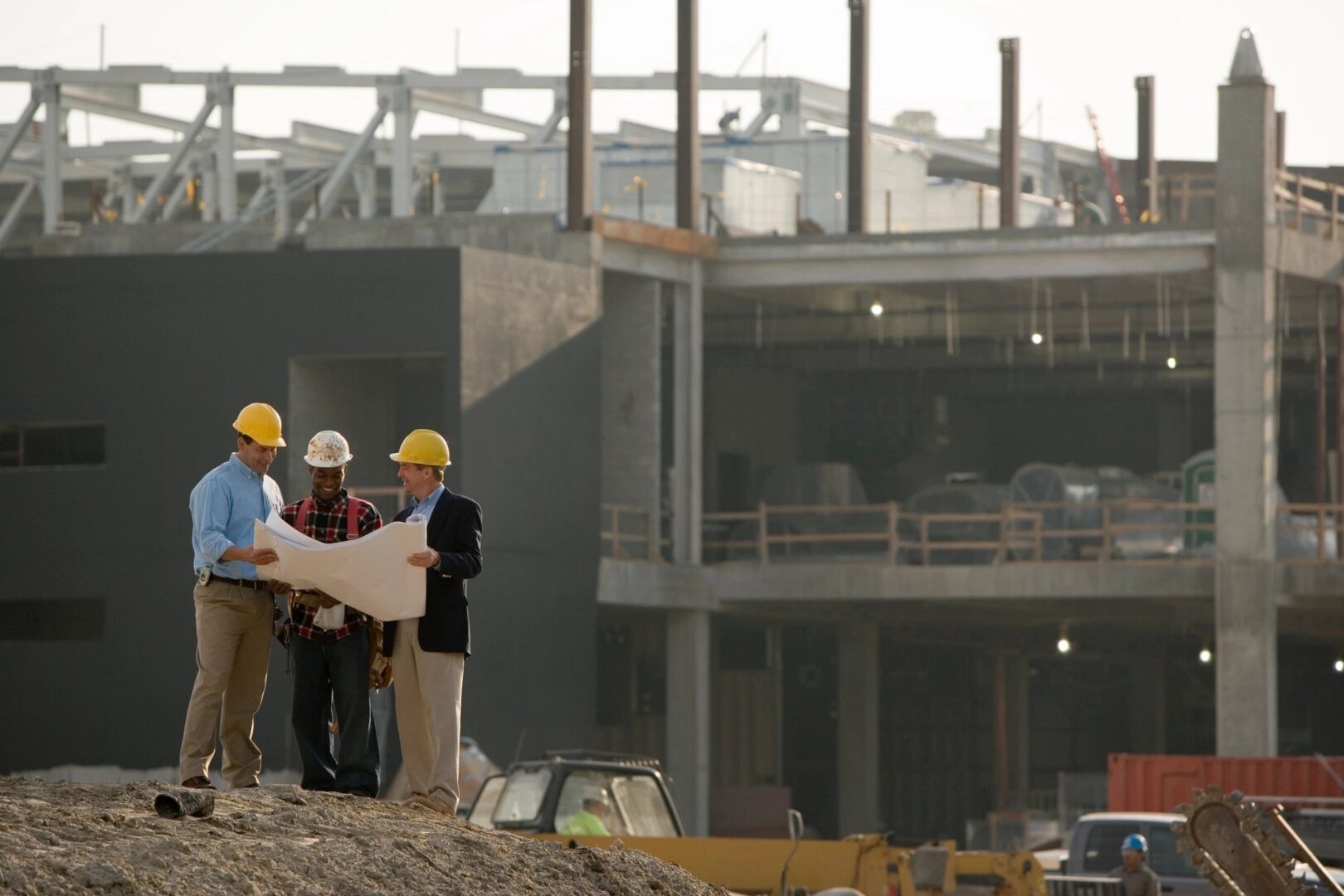 Construction workers reviewing blueprints.